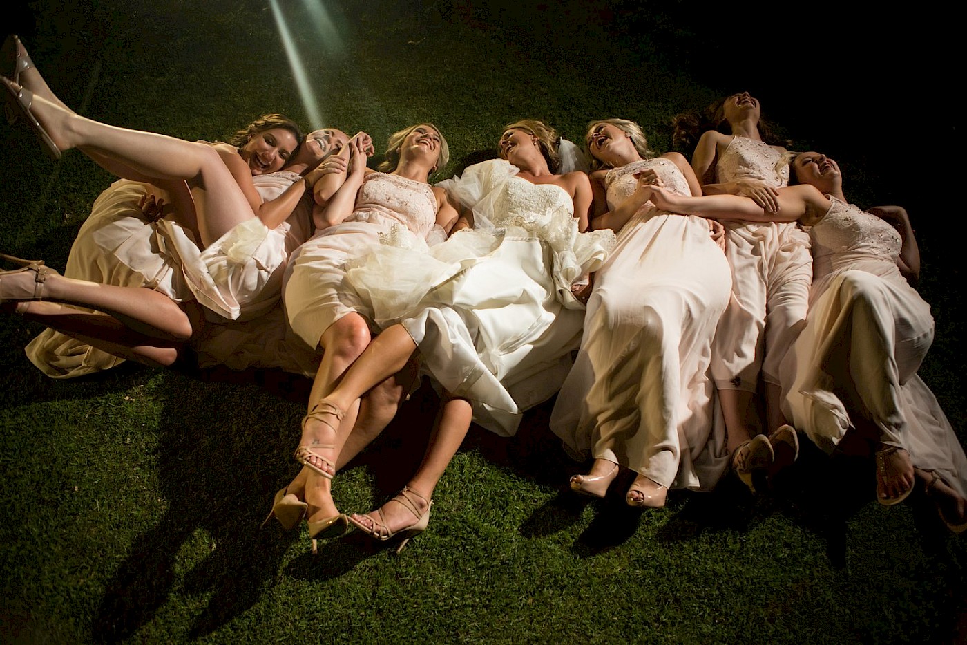 Fallen over Bride and bridesmaids all laughing - wedding Cape Town