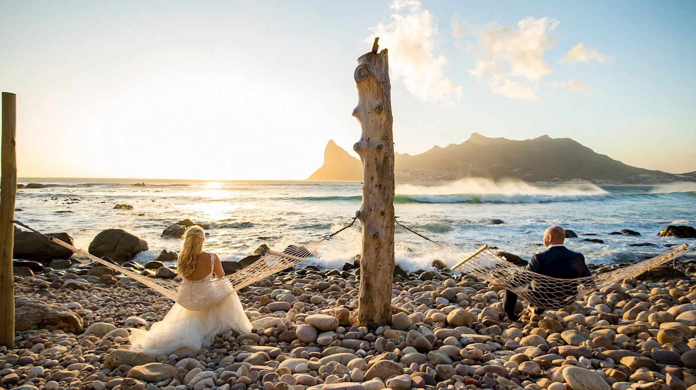 Creative picture newly married couple sitting on hammocks overlooking Hout Bay mountain - Photo Greg Lumley